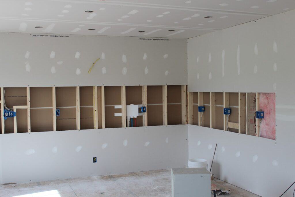 Newly hung and taped drywall in a commercial interior finished by Amaya G Painting