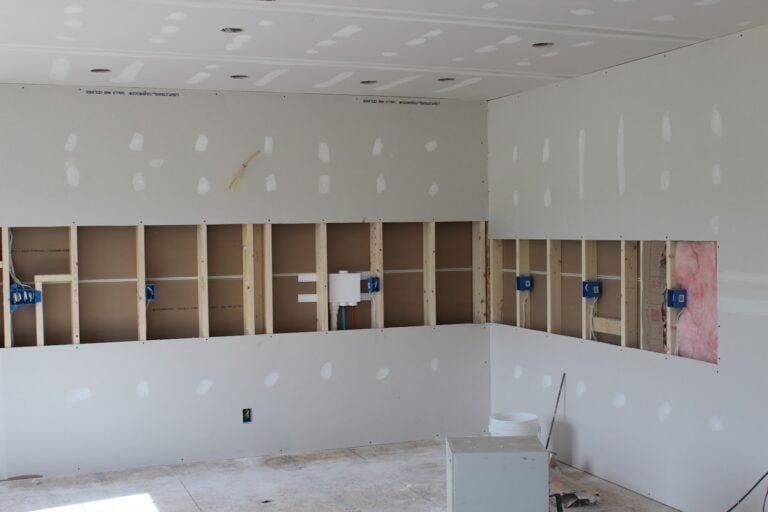 Newly hung and taped drywall in a commercial interior finished by Amaya G Painting
