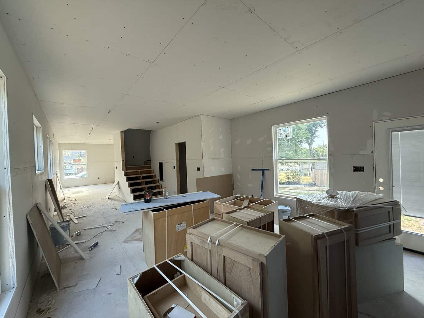 Kitchen cabinetry mid-refinish with fresh white doors going back on